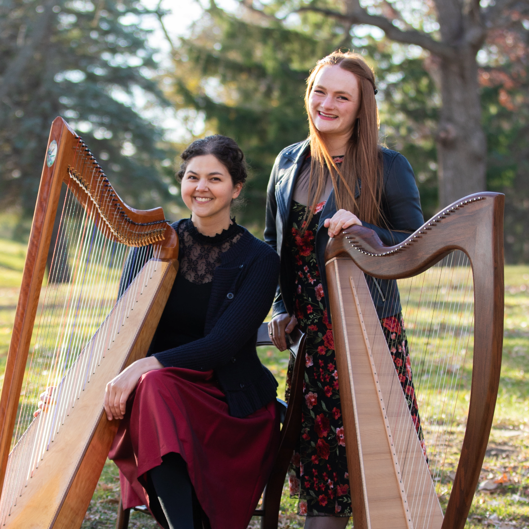 Stephanie Claussen (seated) and Hannah Flowers (standing) with their harps.