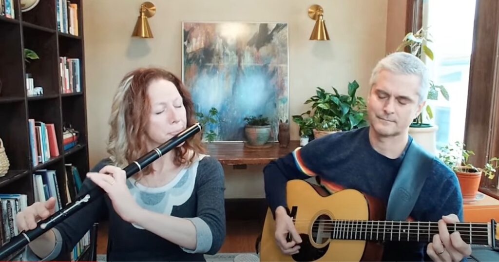 A photo of Shannon Heaton playing the flute and Matt Heaton playing the guitar